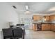 Open kitchen features wood cabinetry, tile flooring, and an adjacent dining area with pool view at 3041 Teal Ave, Sarasota, FL 34232