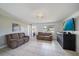 Cozy living room with neutral walls, tile flooring, and comfortable sofa seating at 3041 Teal Ave, Sarasota, FL 34232