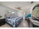 This bedroom features tile floors, a ceiling fan, lots of natural light, and modern furnishings at 3041 Teal Ave, Sarasota, FL 34232