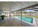 Backyard pool with tiled pool deck and screened in enclosure at 3041 Teal Ave, Sarasota, FL 34232