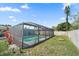 Backyard pool surrounded by a screened enclosure and a well-maintained lawn at 3041 Teal Ave, Sarasota, FL 34232