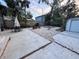 Outdoor space with a concrete patio area, a gravel space with a firepit, and a detached garage at 3312 Bay Shore Rd, Sarasota, FL 34234