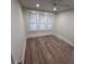 Bright bedroom with hardwood floors, ample natural light, and ceiling fan at 3312 Bay Shore Rd, Sarasota, FL 34234