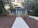 Charming single-story home with a welcoming front porch and a lovely brick walkway at 3312 Bay Shore Rd, Sarasota, FL 34234