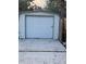 Detached single-car garage with a white door and light siding, offering convenient parking or storage at 3312 Bay Shore Rd, Sarasota, FL 34234