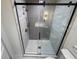 Modern walk-in shower with subway tile, glass doors, and rainfall showerhead at 3312 Bay Shore Rd, Sarasota, FL 34234