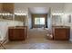 Luxurious bathroom featuring dual vanities, a soaking tub, and recessed lighting in a tiled space at 3607 Twin Rivers Trl, Parrish, FL 34219