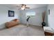 Bedroom features light blue walls, grey carpeting, a ceiling fan and telescope by the window at 3607 Twin Rivers Trl, Parrish, FL 34219