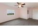 Bright bedroom featuring a ceiling fan, plush carpet, and a large window with a view of the neighborhood at 3607 Twin Rivers Trl, Parrish, FL 34219