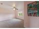 Light-filled bedroom with a ceiling fan, carpet, and a beach-themed canvas at 3607 Twin Rivers Trl, Parrish, FL 34219