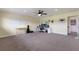 Spacious bonus room featuring carpet, neutral paint, a large desk, and natural light at 3607 Twin Rivers Trl, Parrish, FL 34219