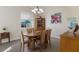 Bright dining room with a wood table, six chairs, and a large window for natural light at 3607 Twin Rivers Trl, Parrish, FL 34219