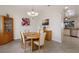 Cozy dining room featuring a wooden table, elegant chairs, and a stylish chandelier at 3607 Twin Rivers Trl, Parrish, FL 34219
