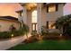Home with a large columned front entrance and manicured lawn at twilight at 3607 Twin Rivers Trl, Parrish, FL 34219