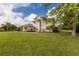 Well-manicured lawn and plantings surrounding a large two-story home with stately columns at 3607 Twin Rivers Trl, Parrish, FL 34219