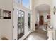 Beautiful front doors leading to a dining room with an elegant buffet and a glass-top table at 3607 Twin Rivers Trl, Parrish, FL 34219