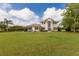 Beautiful home with a large manicured lawn, complemented by tasteful landscaping and mature trees at 3607 Twin Rivers Trl, Parrish, FL 34219