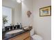 Neat powder room featuring granite countertop, framed mirror, decor, and a toilet at 3607 Twin Rivers Trl, Parrish, FL 34219