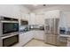 Updated kitchen featuring stainless steel appliances, granite counters, and white cabinetry at 3607 Twin Rivers Trl, Parrish, FL 34219