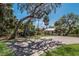 Scenic outdoor space with a covered picnic area, kayak storage, and lush landscaping at 3607 Twin Rivers Trl, Parrish, FL 34219