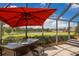 Outdoor bar area adjacent to the screened-in pool, offering seating and views of the green lawn at 3607 Twin Rivers Trl, Parrish, FL 34219