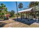Picturesque picnic area with a covered pavilion, seating, and kayak storage near a serene lake at 3607 Twin Rivers Trl, Parrish, FL 34219
