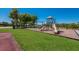 Community playground featuring slides and climbing structures in a lush, green setting at 3607 Twin Rivers Trl, Parrish, FL 34219