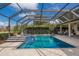 Screened-in pool area features a spa, lush landscaping, and comfortable seating areas at 3607 Twin Rivers Trl, Parrish, FL 34219