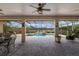Relaxing outdoor screened patio with a lovely pool featuring an elegant tile waterfall design at 3607 Twin Rivers Trl, Parrish, FL 34219