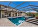 Backyard pool area with a screened-in enclosure, spa, and exterior views of the home at 3607 Twin Rivers Trl, Parrish, FL 34219