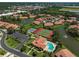 Aerial view of neighborhood showing the tennis courts and the pool at 3890 Wilshire Cir # 27, Sarasota, FL 34238