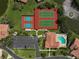 Aerial view of neighborhood showing the tennis courts and the pool at 3890 Wilshire Cir # 27, Sarasota, FL 34238