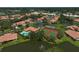 Community aerial view highlighting the pool, tennis courts, and beautiful surrounding landscaping with ponds at 3890 Wilshire Cir # 27, Sarasota, FL 34238
