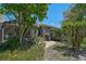 Landscaped backyard with brick patio offers a private outdoor space perfect for relaxation at 3890 Wilshire Cir # 27, Sarasota, FL 34238