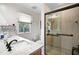 Modern bathroom featuring a glass-enclosed shower and granite-topped vanity at 3890 Wilshire Cir # 27, Sarasota, FL 34238