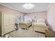 Cozy bedroom featuring twin beds with floral bedding, a large window, and neutral carpet at 3890 Wilshire Cir # 27, Sarasota, FL 34238
