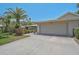 Attractive home exterior showcasing a neutral color palette, lush landscaping, and a spacious driveway at 3890 Wilshire Cir # 27, Sarasota, FL 34238