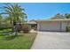 Attractive single-story home boasting a lush front yard, mature landscaping, and a convenient two-car garage at 3890 Wilshire Cir # 27, Sarasota, FL 34238