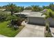 Inviting single-story home showcasing a lush front yard, stone accents, and an attached two-car garage at 3890 Wilshire Cir # 27, Sarasota, FL 34238