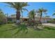 Inviting single-story home showcasing a lush front yard, mature landscaping, and an attached two-car garage at 3890 Wilshire Cir # 27, Sarasota, FL 34238