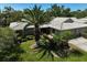 Home featuring lush landscaping, mature palm trees, and manicured lawn at 3890 Wilshire Cir # 27, Sarasota, FL 34238