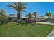 Inviting single-story home featuring well-maintained landscaping and a concrete driveway leading to an attached garage at 3890 Wilshire Cir # 27, Sarasota, FL 34238
