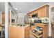 Updated kitchen featuring granite countertops, stainless appliances, and abundant natural light and storage at 3890 Wilshire Cir # 27, Sarasota, FL 34238