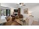 Bright living room with a ceiling fan, a fireplace, and access to the screened patio at 3890 Wilshire Cir # 27, Sarasota, FL 34238