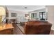Bright living room showcasing hardwood floors, neutral walls, and large sliding glass doors at 3890 Wilshire Cir # 27, Sarasota, FL 34238