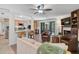 Bright living room with access to the kitchen, fireplace, comfy seating, and a sliding glass door to the patio at 3890 Wilshire Cir # 27, Sarasota, FL 34238