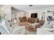 Open-concept living room features wood floors, an antique light, and comfortable seating for relaxing or entertaining at 3890 Wilshire Cir # 27, Sarasota, FL 34238