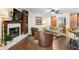 Comfortable living room with fireplace, built-ins, and a view into the kitchen at 3890 Wilshire Cir # 27, Sarasota, FL 34238