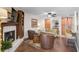 Inviting living room with fireplace, wood floors, and built-in cabinets at 3890 Wilshire Cir # 27, Sarasota, FL 34238