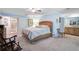 Airy main bedroom with light blue walls, a king bed, and an attached bathroom and walk-in closet at 3890 Wilshire Cir # 27, Sarasota, FL 34238